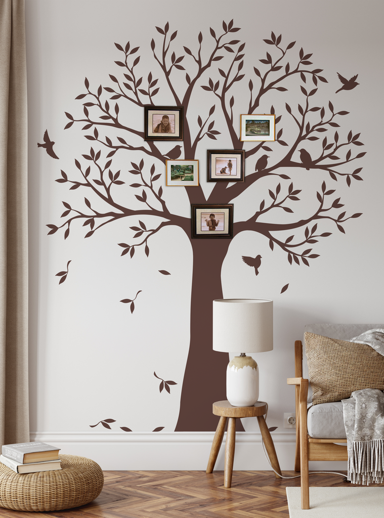 Large brown family tree wall decal with branches and leaves, displaying framed photos. Stylish home decor for showcasing family memories. Includes flying birds and falling leaves. Shown in cozy living room setting with lamp and furniture. Top Sellers,Wall Decals,Family Tree Decals,All Products