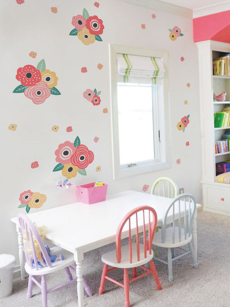 Vibrant flowers in bloom adorn the walls, creating a charming and whimsical atmosphere in this delightful kids' room. Featuring a variety of colorful blooms in various sizes, this eye-catching wall decor adds a burst of natural beauty and warmth to the space. The assortment of flower stickers offers versatility, allowing the arrangement to be customized to suit any child's preferences. This captivating design is perfect for transforming a nursery